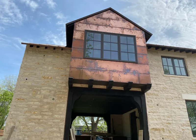 Copper metal panel facade on a stone building for Skylight Installation in Willowbrook