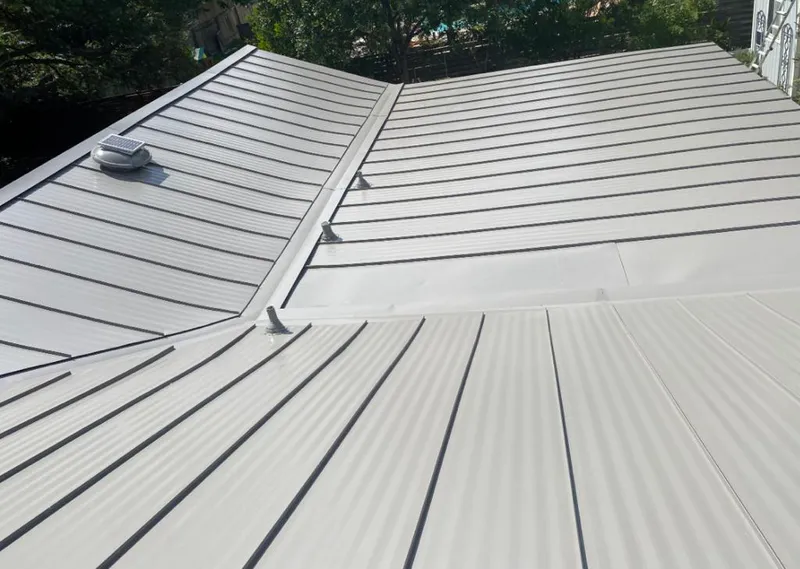Solar attic fan installed on a metal roof for Roof Ventilation in Willowbrook